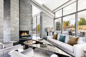 Lobby with floor to ceiling windows and a towering ceiling