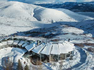 Snowy aerial view featuring a mountain view