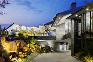 View of side of home with stone siding and a chimney