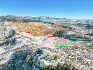 View of property location with a mountainous background and property boundaries highlighted