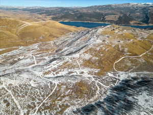 Snowy aerial view with a water and mountain view