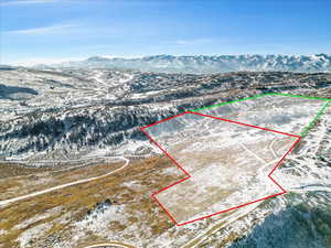 Aerial overview of property's location with property parcel outlined and mountains
