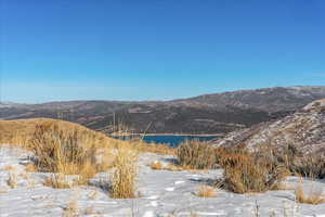 View of mountain backdrop featuring a nearby body of water