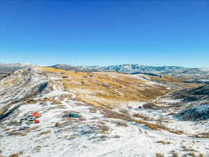 Snowy aerial view featuring a mountain view