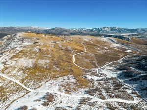 Snowy aerial view featuring a mountain view