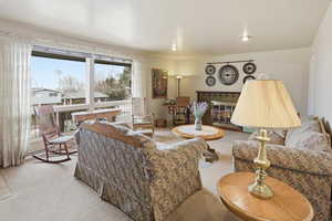 Living room featuring carpet floors and a brick fireplace