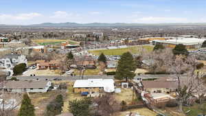 Aerial overview of property's location with nearby suburban area and mountains