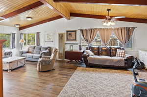 Living area with ceiling fan, wood finished floors, and wood ceiling