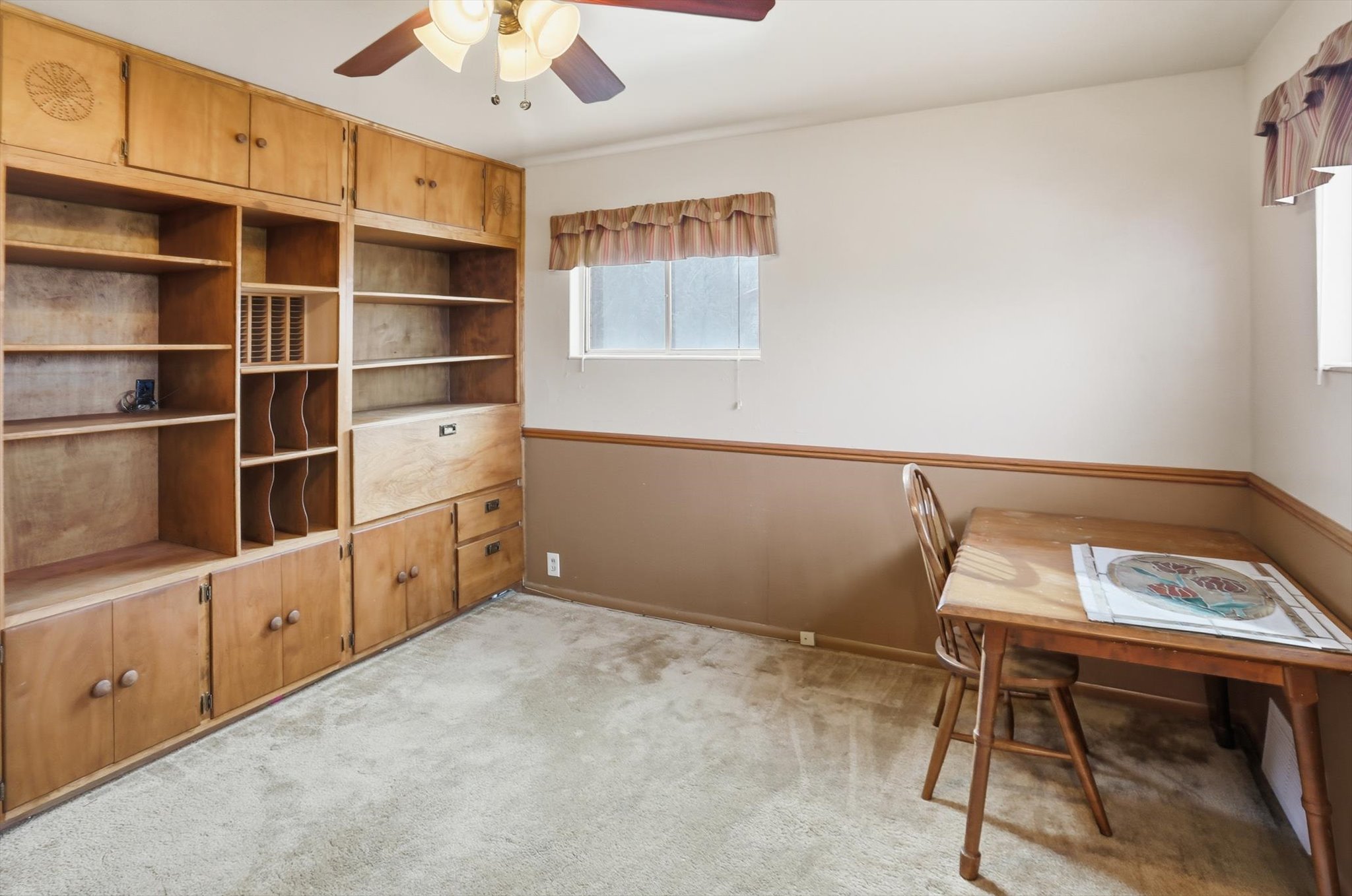Home office featuring light colored carpet and ceiling fan