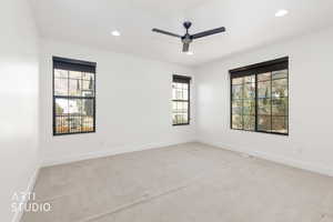 Unfurnished room with light colored carpet, recessed lighting, ceiling fan, and plenty of natural light