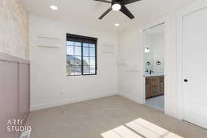 Unfurnished bedroom with light colored carpet, ceiling fan, ensuite bath, and recessed lighting