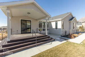 Back of house featuring stucco siding, a patio area, and a mountain view