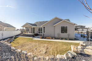 Rear view of house with roof with shingles and stucco siding