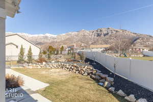 Fenced backyard with a mountain view
