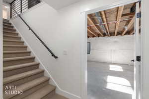 Staircase featuring concrete flooring