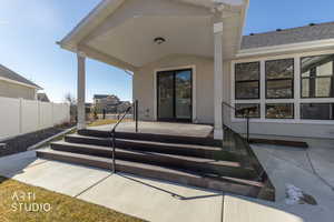 Entrance to property with a patio area and stucco siding