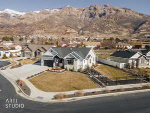 View of front facade featuring driveway, a residential view, and a mountain view