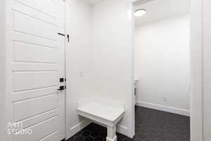 Mudroom with dark tile patterned floors