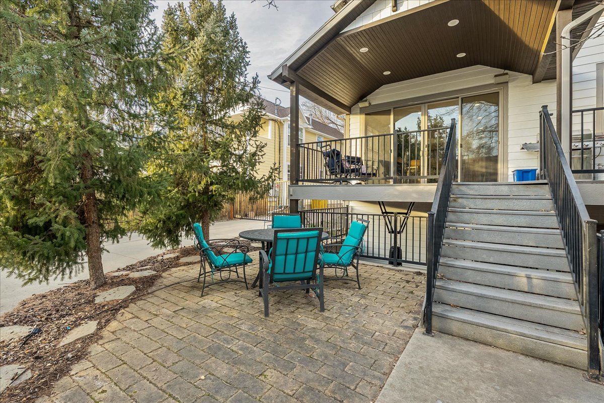 View of large covered deck.  Below is covered patio and basement entrance.