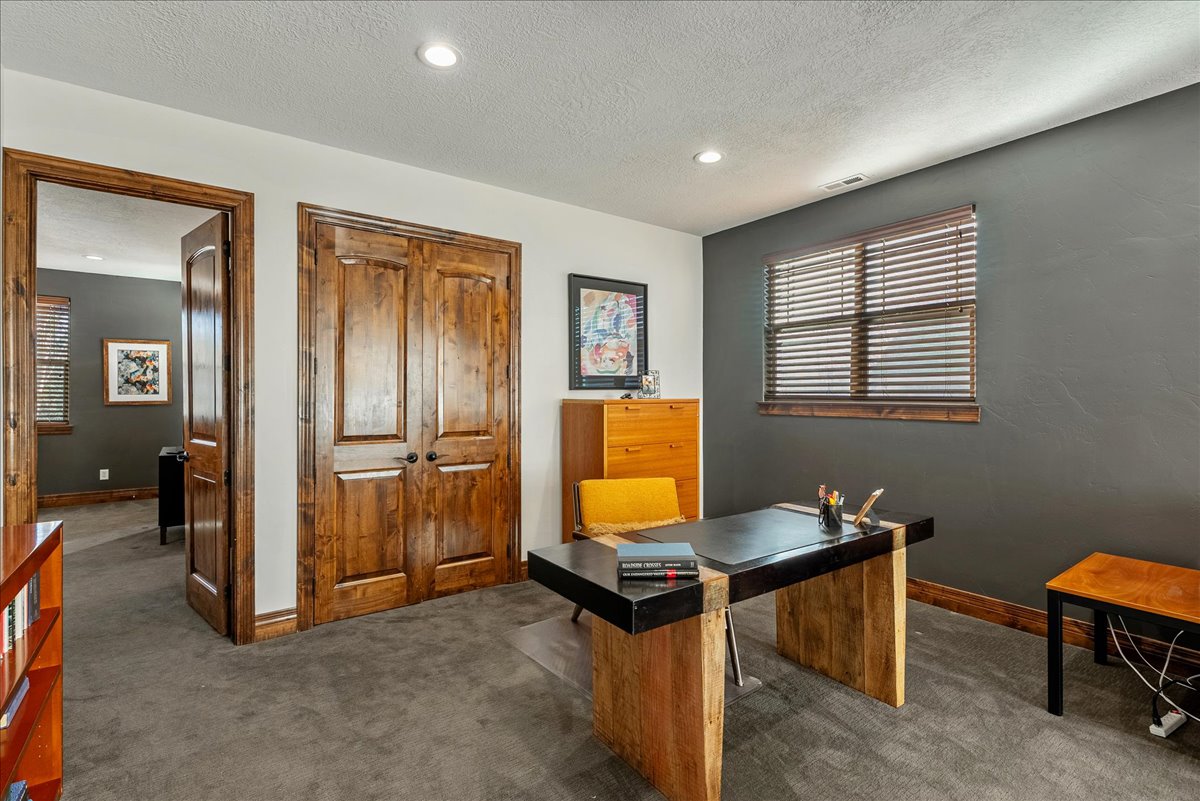 On the top level, an open-concept loft offers a versatile retreat—ideal as a home office, media lounge, or inviting family room.