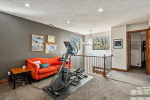 On the top level, an open-concept loft offers a versatile retreat—ideal as a home office, media lounge, or inviting family room—while providing an elegant overlook to the home’s grand entry below.