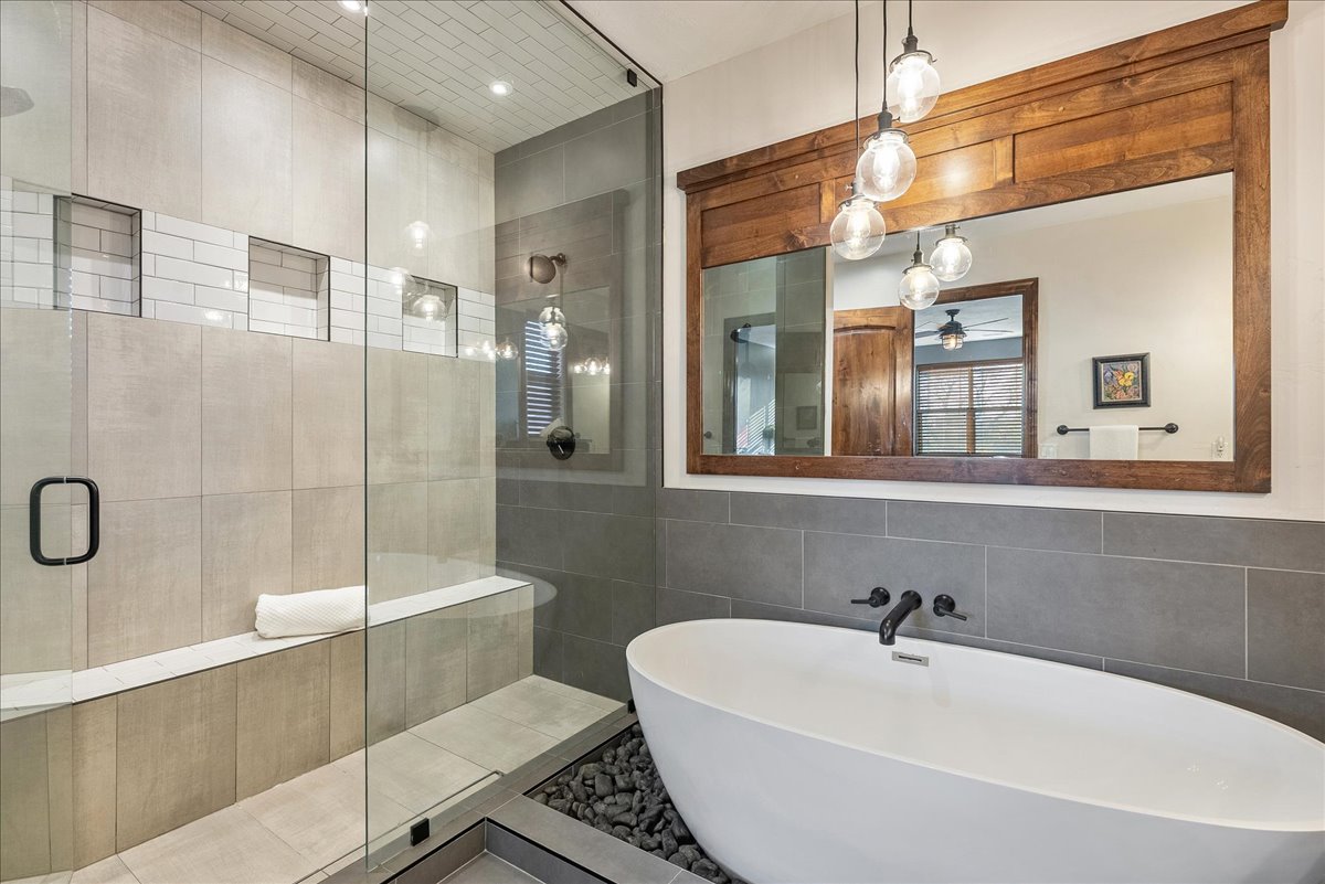 Grand primary bathroom featuring a spacious double vanity, a freestanding luxury soaking tub, and an expansive walk-in shower designed for a spa-like experience.