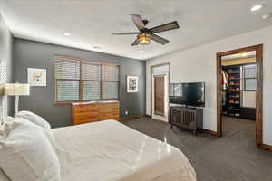 Primary suite view toward the door opening to the private second-story balcony, inviting seamless indoor-outdoor relaxation.