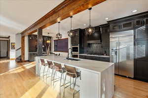 Sightline to the gourmet kitchen, beautifully anchored by an expansive central island beneath elegant pendant lighting.