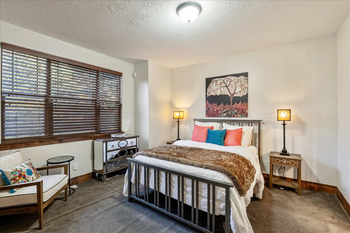 Main-level bedroom suite featuring a private ensuite with a full, beautifully appointed bathroom.