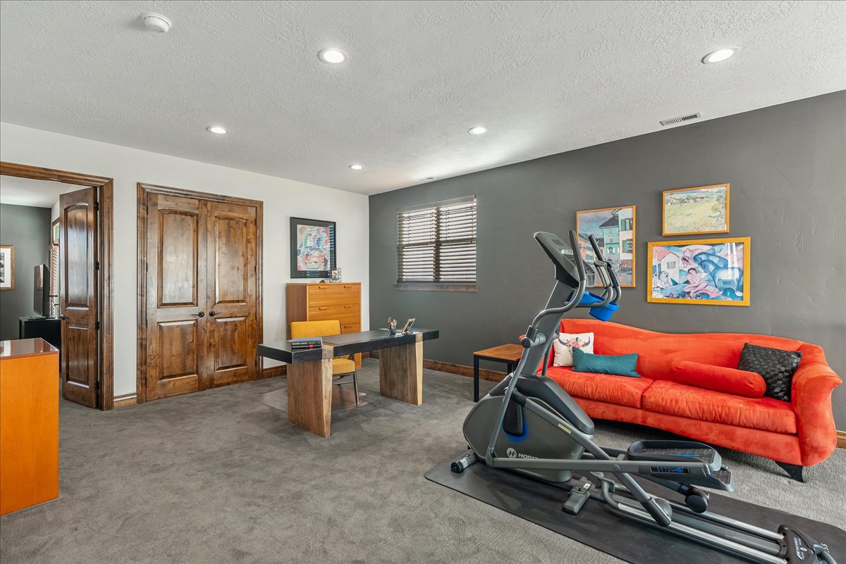 On the top level, an open-concept loft offers a versatile retreat—ideal as a home office, media lounge, or inviting family room.