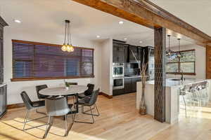 Dining room featuring light wood finished floors, a chandelier, and recessed lighting