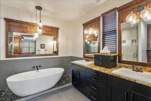 Grand primary bathroom featuring a spacious double vanity, a freestanding luxury soaking tub, and an expansive walk-in shower designed for a spa-like experience.