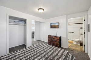Bedroom featuring carpet, a closet, and connected bathroom