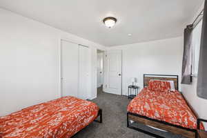 Bedroom featuring carpet floors and a closet