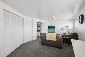 Carpeted living area with baseboards