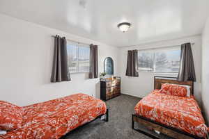 Bedroom featuring carpet and baseboards