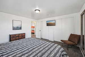 Bedroom featuring a closet and carpet flooring