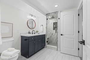 Downstairs en suite bath with Frameless Euro Glass Shower that also offers access from the living room.