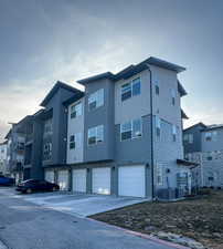 Rear view of house featuring stucco siding and an attached garage