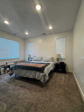 Bedroom with carpet flooring and a textured ceiling