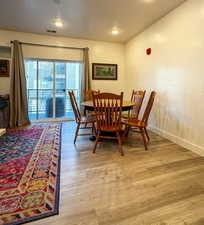 Dining space featuring light wood-style flooring, a textured ceiling, and recessed lighting
