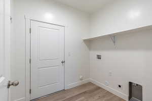 Laundry room with light wood finished floors, gas dryer hookup, washer hookup, and hookup for an electric dryer