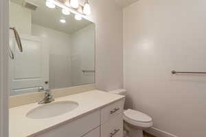 Bathroom featuring vanity and toilet