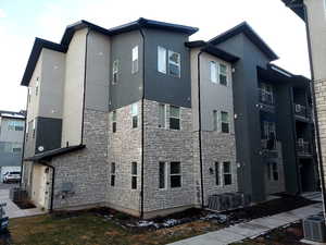View of home's exterior featuring stone siding and stucco siding