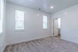 Unfurnished bedroom with baseboards and carpet flooring