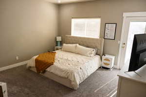 Bedroom featuring carpet and access to outside