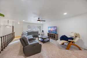 Living area featuring ceiling fan, light colored carpet, ornamental molding, and recessed lighting