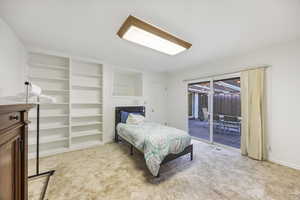 Bedroom featuring light colored carpet, a closet, and access to exterior