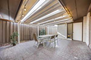 Fenced backyard featuring outdoor dining area and a patio