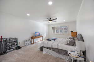 Carpeted bedroom with crown molding, recessed lighting, and a ceiling fan